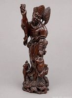 Full view of entire carved wooden figurine showing overall form and height
