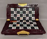 Board opened showing inlaid squares and carved frame