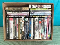 Overall view of open carton showing horizontal and vertical rows of DVD cases