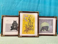 Front view of the three framed Edward Gorey prints