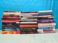 Full view of all stacked books showing spines and quantity