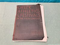 Front of portfolio folder showing title and edge wear