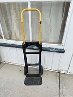 Front view of Harper hand truck with yellow handle and footplate