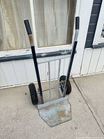 Full view of hand truck front showing frame, handles and nose plate