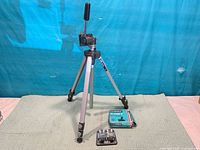 Full view of tripod standing with Hanimex box and splicer base on mat