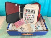 Box containing binder, album pages, plastic compartment case and loose stamps