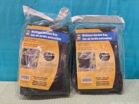 Both factory-sealed PowerFist garden bags front view showing retail labels