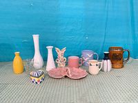 All 12 ceramic pieces and the cut glass vase arranged side by side