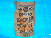 Full view of front of burlap sack showing graphics and size