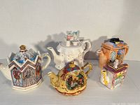 Group shot of all five novelty ceramic teapots