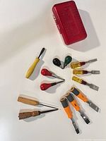 All chisels and punches laid out around red case