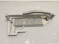Top view of manual tile cutter showing handle, scoring wheel and cutting bed