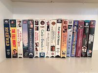 Full row of 16 VHS tapes on shelf