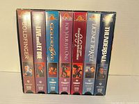 Seven James Bond VHS tapes in slipcase, spine view