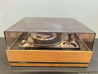 Turntable in wood base with dust cover on