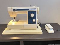 Front view of Kenmore model 10 sewing machine on base with foot pedal