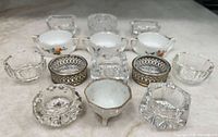 All 14 salt cellars laid out to show variety and condition