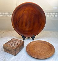 All three wooden items: platter on stand, carved plate, carved box