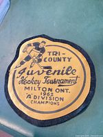 Front of yellow/black felt hockey tournament patch