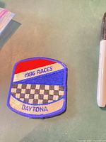 Front view of embroidered patch showing text and checkered design