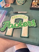 Front of chenille patch showing colors and text