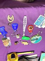 Overview of assorted keychains on purple cloth