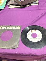 Record with Columbia sleeve on purple surface