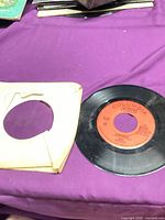 Record and torn paper sleeve on table