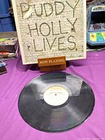 Front sleeve with Buddy Holly Lives text and vinyl record front side