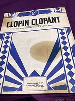 Front cover showing full title, composers, decorative border and water stain