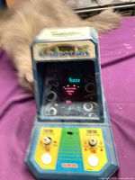 Front view of Coleco Galaxian tabletop game powered on showing display and control panel
