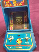 Front view of Coleco Ms. Pac-Man tabletop arcade showing controls and cabinet graphics