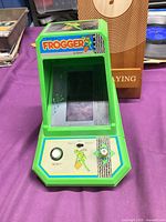 Front angled view showing screen, control panel and Frogger logo