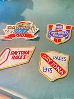 Front view of four Daytona embroidered patches displaying years 1975, 1982, 1997 and undated patch
