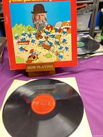Front cover with Father Abraham and Smurfs artwork, record on inner sleeve visible