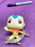 Front view of Aang Funko Pop figure showing pose, outfit, swirling effect, and staff