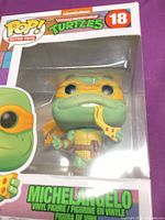 Front view of boxed Funko Pop Michelangelo #18 showing figure and window display
