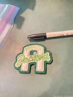 Front of embroidered Packers patch next to Sharpie for scale
