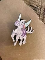 Front view of hard enamel fantasy creature lapel pin showing colors and design