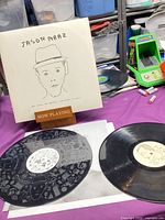 Album jacket on stand with both vinyl discs displayed