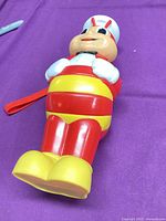 Front view of Jollibee figure showing colors, strap, overall condition