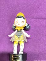 Front view of Laura vinyl figurine on base