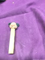 Full view of PEZ dispenser on purple background