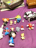 Overall view of assorted figures on purple surface