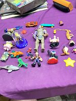 Group shot of entire lot on purple cloth including Thanos, vehicles, figures and accessories