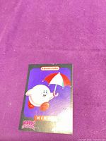 Front of Kirby's Adventure promotional card showing graphics and logos