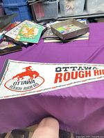 Full view of Ottawa Rough Riders felt pennant on table