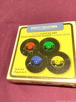 Front of boxed LP Vinyl Coaster Set showing four coloured record-style coasters