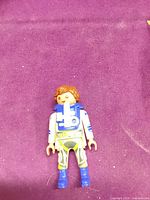Front view of Playmobil figure showing suit graphics and breathing pack