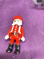 Front view of Playmobil Santa figure showing suit, boots and beard